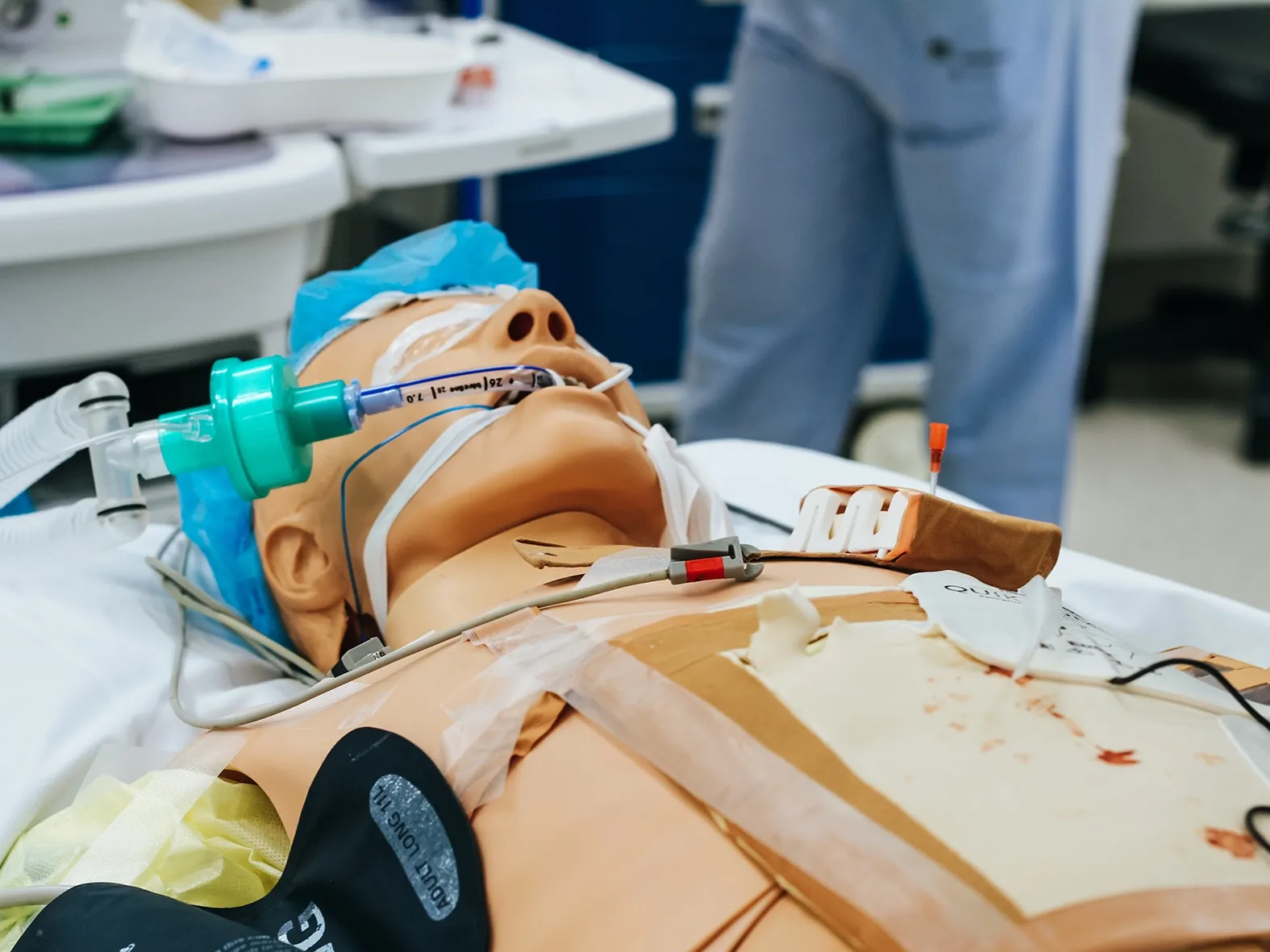 Medizinische Übungspuppe mit Beatmungsschlauch und Infusion für Notfall- oder Intensivsimulation.